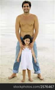 Portrait of a father and his daughter on the beach