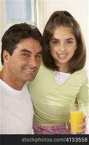 Portrait of a father and his daughter smiling