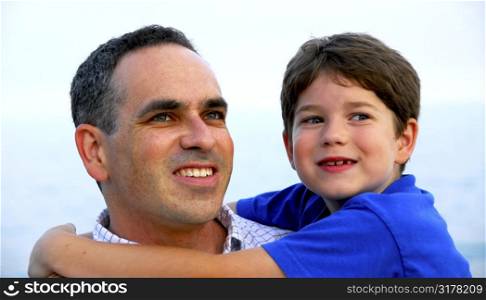 Portrait of a father holding his son