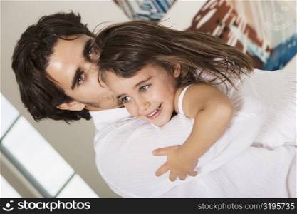 Portrait of a father hugging his daughter