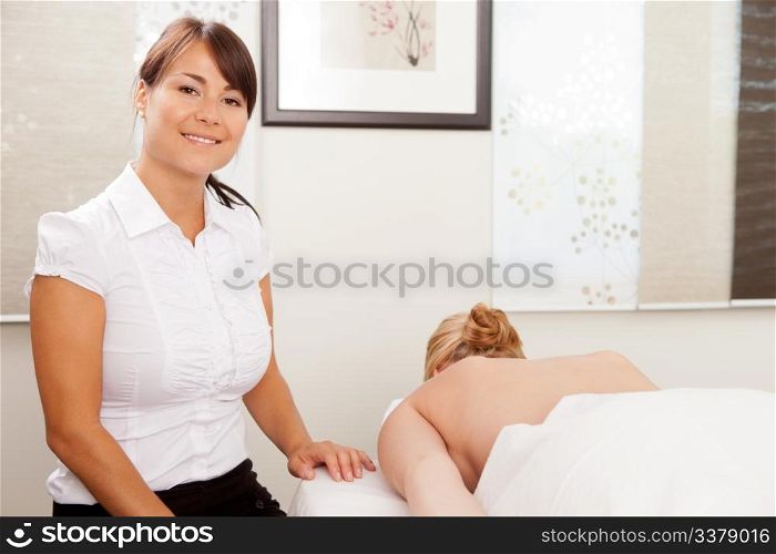 Portrait of a female acupuncturist with patient
