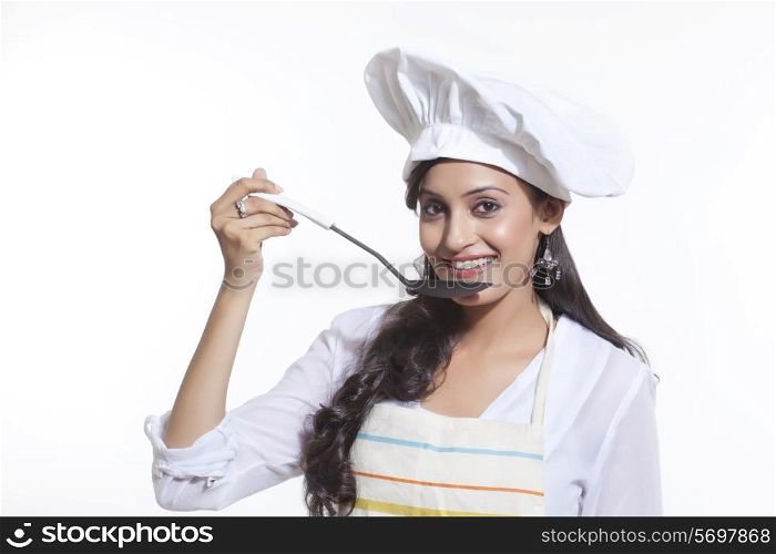 Portrait of a female chef tasting