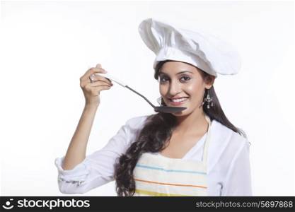 Portrait of a female chef tasting
