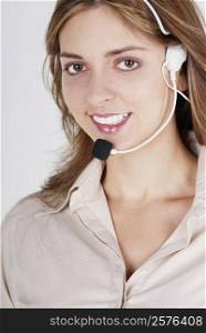 Portrait of a female customer service representative talking on a headset and smiling