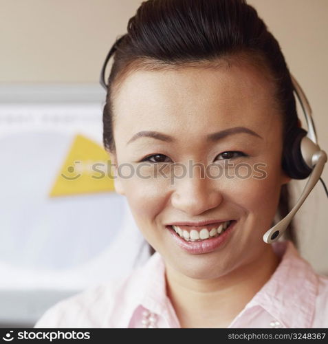 Portrait of a female customer service representative talking on a headset and smiling
