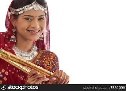 Portrait of a female dandiya dancer with sticks