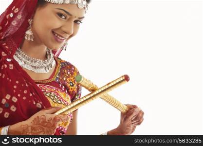 Portrait of a female dandiya dancer with sticks