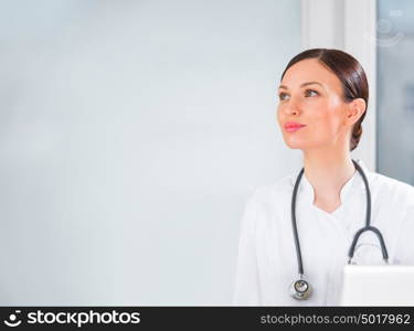 Portrait of a female doctor at clinic looking at copyspace and smiling