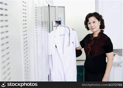 Portrait of a female doctor holding a lab coat