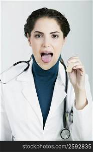 Portrait of a female doctor sticking her tongue out