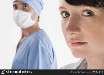 Portrait of a female doctor with a male surgeon
