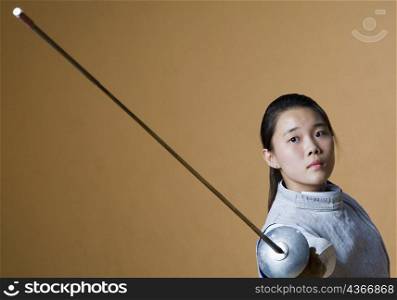 Portrait of a female fencer fencing