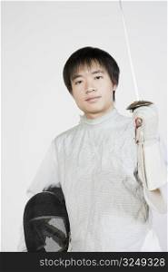 Portrait of a female fencer holding a fencing foil and a fencing mask