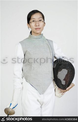Portrait of a female fencer holding a fencing foil and a fencing mask