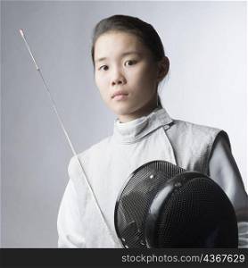 Portrait of a female fencer holding a sword and a fencing mask