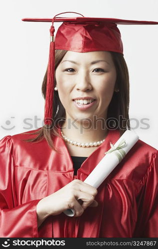 Portrait of a female graduate holding a diploma