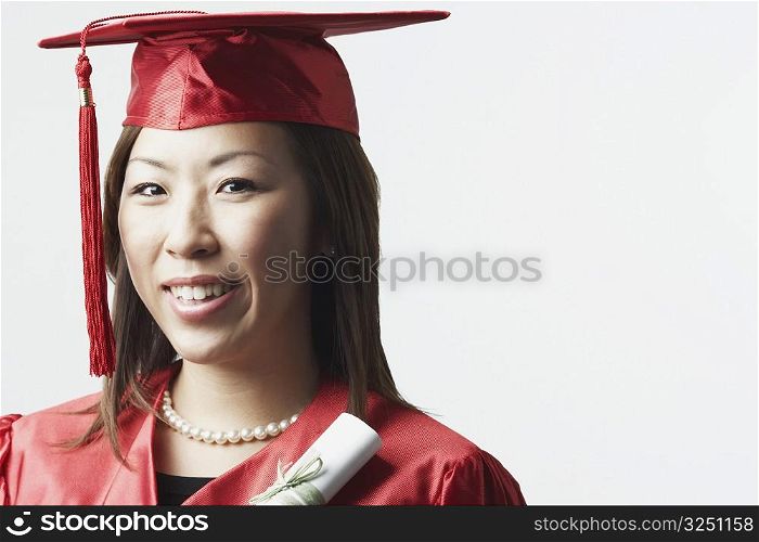 Portrait of a female graduate holding a diploma