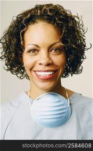 Portrait of a female nurse smiling and wearing scrubs