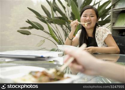 Portrait of a female office worker having lunch and smiling