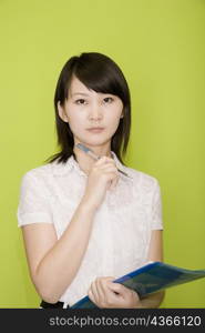 Portrait of a female office worker holding a file