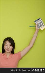 Portrait of a female office worker holding stationery objects