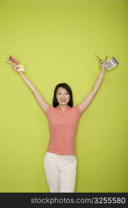 Portrait of a female office worker holding stationery objects