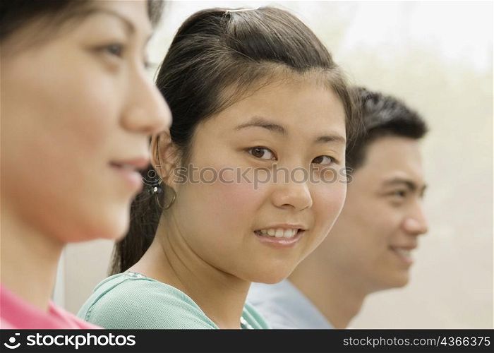 Portrait of a female office worker smiling with her colleagues