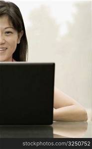 Portrait of a female office worker using a laptop
