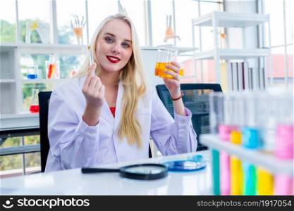 portrait of a female researcher carrying out research in a chemistry lab scientist holding test tube with sample in Laboratory analysis background