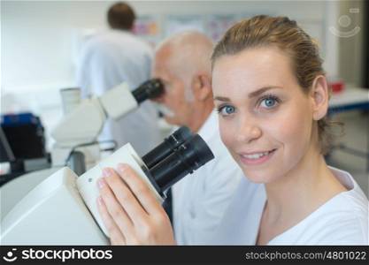 portrait of a female scientist with microscope
