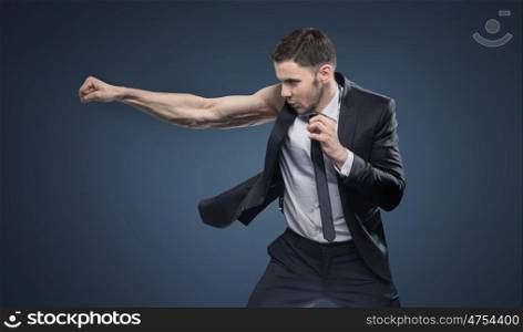 Portrait of a fighting muscular businessman