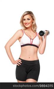 Portrait of a fit, young white female athlete with curly long blond hair posing by herself holding a dumbbell in a studio with white background wearing black shorts   sports bra.
