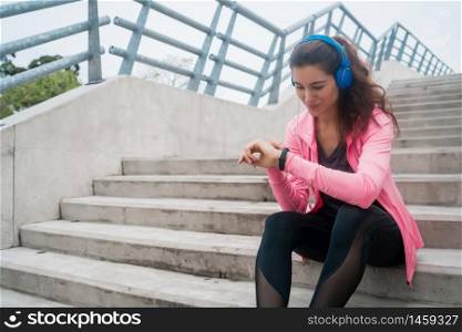Portrait of a fitness woman monitoring her progress on smart watch. Sport and healthy lifestyle concept.