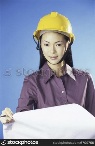 Portrait of a forewoman holding a blueprint