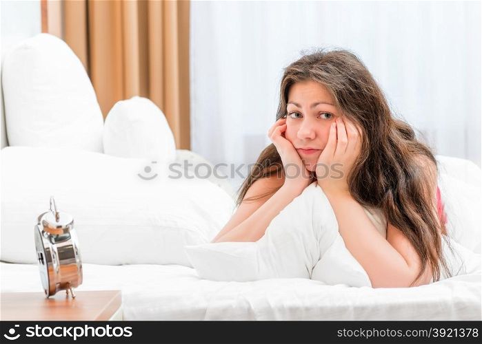 Portrait of a frustrated woman in bed in the morning