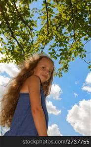 Portrait of a girl against bright blue sky.