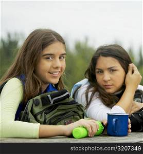 Portrait of a girl and her friend holding a mug