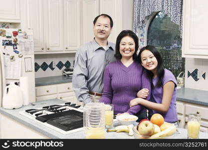 Portrait of a girl and her parents in the kitchen