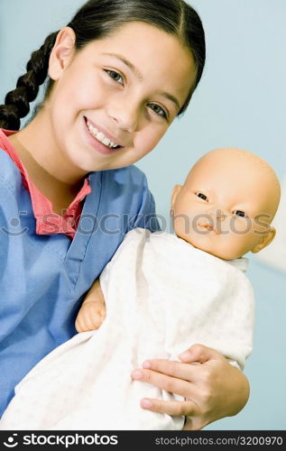 Portrait of a girl carrying a doll and smiling