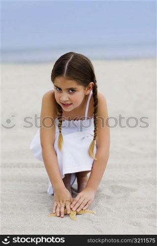 Portrait of a girl crouching on the beach