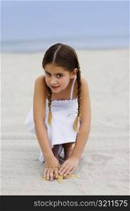 Portrait of a girl crouching on the beach