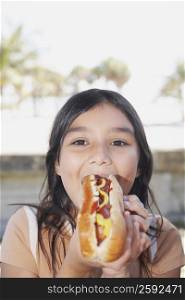 Portrait of a girl eating a hot dog