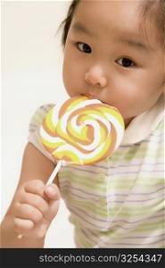 Portrait of a girl eating a lollipop