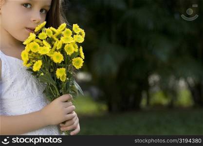 Portrait of a girl holding a bunch of flowers