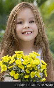 Portrait of a girl holding a bunch of flowers and smiling