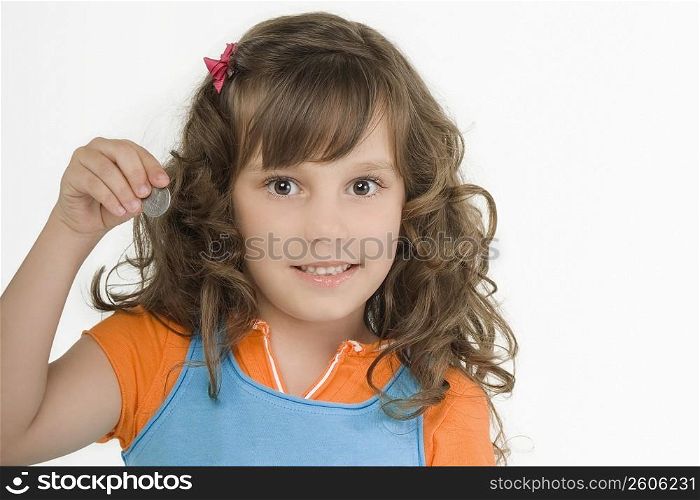 Portrait of a girl holding a coin