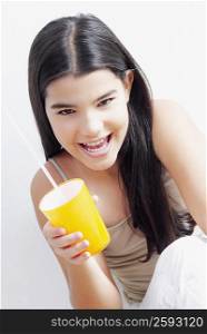 Portrait of a girl holding a glass and smiling