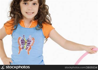 Portrait of a girl holding a hula hoop and smiling