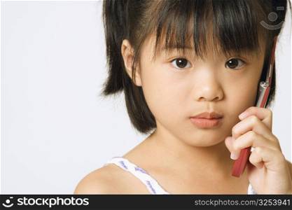 Portrait of a girl holding a mobile phone