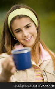 Portrait of a girl holding a mug